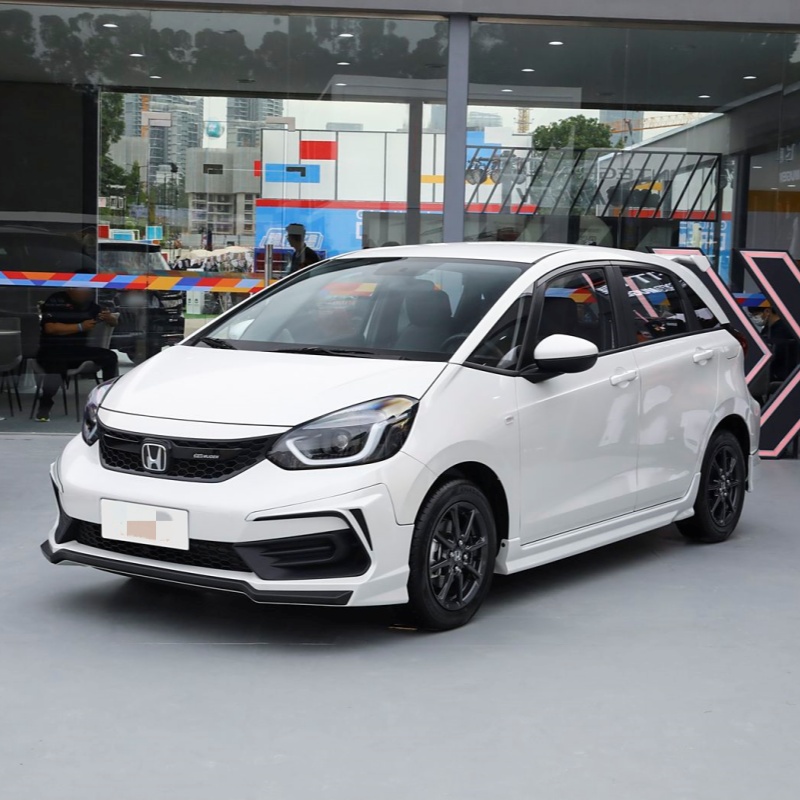 The Honda Fit is the ultimate urban compact car, offering exceptional fuel efficiency and surprising interior space in a small package. This versatile hatchback features Honda's renowned 1.5L i-VTEC e